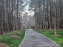 Charming home nestled among trees with a patterned driveway and well-manicured lawn at 1832 Marthas Vineyard Rd, York, SC 29745