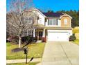 Attractive two-story home with a well-maintained lawn, complemented by solar panels on the roof at 1923 Caprington Dr, Fort Mill, SC 29707