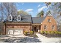 Traditional brick home with a well-manicured front yard, two-car garage and driveway at 25 Blenheim Ne Ct, Concord, NC 28025