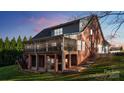 Expansive backyard featuring a screened porch, brick columns, and multiple levels for outdoor living and entertaining at 2846 Snead Ne Ct, Conover, NC 28613