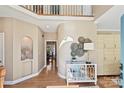 Elegant foyer featuring hardwood floors, modern decor, and built-in storage cabinets at 2901 Barnard Castle Ln, Matthews, NC 28104