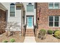 Charming home featuring a blue front door, brick steps, and a combination brick and siding exterior at 2901 Barnard Castle Ln, Matthews, NC 28104