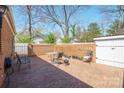 Brick patio with outdoor seating surrounded by a wooden and brick fence at 311 S Cedar St # C, Lincolnton, NC 28092
