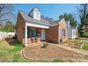 Charming brick home featuring a dormer window, blue shutters and small front porch at 311 S Cedar St # C, Lincolnton, NC 28092