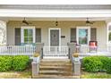 Inviting front porch with ceiling fans, seating, and lush landscaping creates a welcoming entrance at 329 N Ellis St, Salisbury, NC 28144