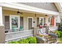 Charming front porch featuring ceiling fans, seating area, and decorative flower boxes at 329 N Ellis St, Salisbury, NC 28144