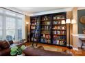 Inviting living room with built-in bookcase, wood floors, neutral walls and comfortable seating at 4232 Belle Meade Cir, Belmont, NC 28012
