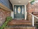 Inviting front entrance featuring a decorative door with sidelights and brick steps at 4522 Chuckwood Dr, Mint Hill, NC 28227