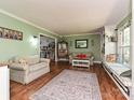 Cozy living room with built-in shelving, window seating, and a comfortable seating arrangement at 4522 Chuckwood Dr, Mint Hill, NC 28227