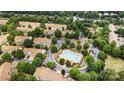 Overhead view of a neighborhood featuring townhomes, a pool, mature trees and green spaces at 4818 Grier Farm Ln, Charlotte, NC 28270
