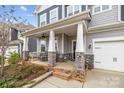 Inviting front porch with stone supports and comfortable seating at 5030 Lily Pond Cir, Waxhaw, NC 28173