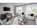 Bright living room with hardwood floors, large windows, stylish furniture, and modern decor at 5045 Grain Orchard Rd # 3027D, Indian Trail, NC 28079