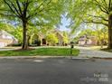 Spacious home with lush landscaping, a long driveway, and a detached garage at 5811 Old Well House Rd, Charlotte, NC 28226