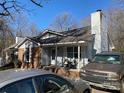 Inviting home exterior with a cozy front porch, a well-manicured lawn, and ample parking space in the driveway at 6536 Pineburr Rd, Charlotte, NC 28211