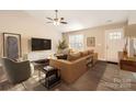 Bright living room showcasing a comfortable leather couch, modern furnishings, and sleek wood floors at 714 Sunset Dr, Salisbury, NC 28147