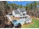 Expansive backyard featuring a sparkling pool, patio, and lush landscaping, perfect for outdoor living at 7322 Bay Ridge Dr, Denver, NC 28037