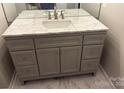 Stylish bathroom vanity with marble countertop, gray cabinetry, and modern fixtures at 9068 Cinnabay Dr, Charlotte, NC 28216