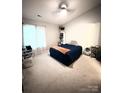 Cozy bedroom featuring a large bed, soft carpet, and plenty of natural light from the windows at 9068 Cinnabay Dr, Charlotte, NC 28216