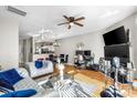 Bright living area with hardwood floors, ceiling fan, and fireplace at 9068 Cinnabay Dr, Charlotte, NC 28216