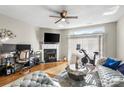 Bright living area with hardwood floors, a ceiling fan, and access to the backyard at 9068 Cinnabay Dr, Charlotte, NC 28216
