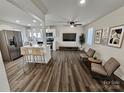 Open-concept living area with wood floors, sleek kitchen, and modern finishes, creating a perfect space for entertaining and relaxation at 915 2Nd St, Kings Mountain, NC 28086