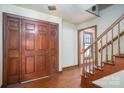 Inviting foyer featuring hardwood floors, grand wooden front door, and staircase at 1008 High Wedge Rd, Shelby, NC 28152