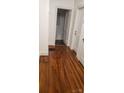 Hallway with gleaming hardwood floors leading to rooms with doors and trim at 1109 West Blvd, Charlotte, NC 28208