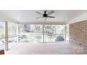 Screened patio with brick floor, fan, and outdoor view at 116 Jonas Dr, Lincolnton, NC 28092
