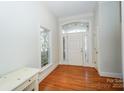 Inviting foyer with hardwood floors and transom windows above double front doors and next to front window at 124 Gatlin Knl # 11, New London, NC 28127
