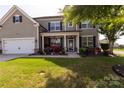 Charming two-story home with a well-manicured lawn and inviting front porch at 1501 Allegheny Way, Waxhaw, NC 28173