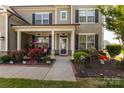 Inviting covered front porch with stylish decor and charming curb appeal at 1501 Allegheny Way, Waxhaw, NC 28173