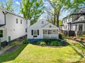 Aerial view of a cute cottage home with a front porch and beautifully manicured lawn at 1631 Fulton Ave, Charlotte, NC 28205