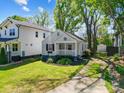 Quaint cottage home with well-maintained lawn, garden beds, and a private driveway at 1631 Fulton Ave, Charlotte, NC 28205