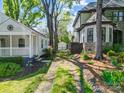 Side yard view of the cottage home showing a driveway and a detached garage at 1631 Fulton Ave, Charlotte, NC 28205