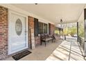 Inviting front porch featuring comfortable seating and a welcoming entrance to the charming brick home at 1923 Tracy Ct, Fort Mill, SC 29708