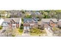 Aerial view of a residential neighborhood showcasing a brick two-story home with a two-car garage at 2014 Arbor Crest Ct, Charlotte, NC 28262