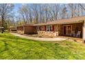 Inviting entrance featuring a mix of stone and brickwork, leading to a cozy covered front porch at 220 Gregory Rd, Salisbury, NC 28147