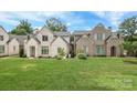 Beautiful brick homes with green lawns and manicured landscaping under a bright blue sky at 3119 Knowlton Ln, Charlotte, NC 28205