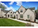 Beautiful white brick homes showcasing meticulous landscaping and inviting sidewalks under a sunny sky at 3119 Knowlton Ln, Charlotte, NC 28205