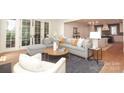 Open concept living room with lots of natural light, a gray sofa, and a round coffee table at 3119 Knowlton Ln, Charlotte, NC 28205