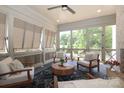 Relaxing screened porch with comfortable seating, decorative rug and lots of natural light at 3119 Knowlton Ln, Charlotte, NC 28205