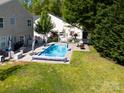 An aerial view shows a sparkling pool, spacious backyard, and a glimpse of the neighborhood's lush greenery at 320 Allspice Rd, Fort Mill, SC 29708