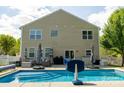 The backyard features a sparkling inground pool, ample seating, and lush greenery creating a relaxing outdoor oasis at 320 Allspice Rd, Fort Mill, SC 29708