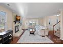 Inviting living room featuring hardwood floors, a cozy fireplace, and comfortable seating at 3217 Deep Meadow Ln, Charlotte, NC 28210