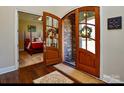 Inviting foyer featuring beautiful hardwood floors, arched door, and views of the bedroom at 341 Canvasback Rd, Mooresville, NC 28117
