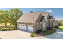 Spacious three-car garage with ample parking and a brick exterior at 341 Canvasback Rd, Mooresville, NC 28117