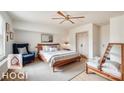 Cozy bedroom with a ceiling fan, accent chair, and wooden bed frame, offering a relaxing and comfortable space at 3905 Farlow Rd, Charlotte, NC 28269