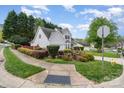 Landscaped corner lot featuring a two-story home, mature trees, and well-maintained shrubbery at 3905 Farlow Rd, Charlotte, NC 28269