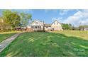 Beautiful backyard view featuring a spacious lawn perfect for entertaining at 421 Tranquil Bay Cir, Norwood, NC 28128