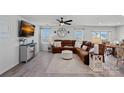Spacious living room with hardwood floors, a large sectional sofa, and plenty of natural light at 4318 Greenleaf Nw St, Concord, NC 28027